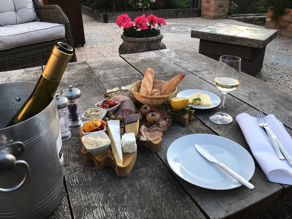 A platter on the patio & a glass of chilled Pinot at Piglets Boutique B&B