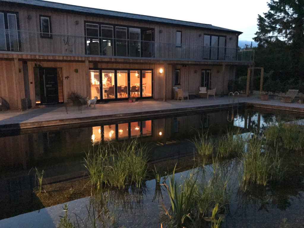 Piglets Boutique B&B across the swimming pond at night