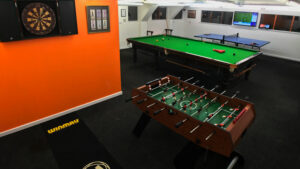 Games room at Piglets Boutique Country Stay showing darts, Foosball, full size snooker and table-tennis for guests