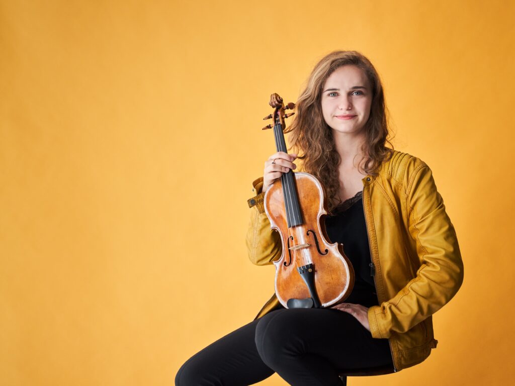 Charlotte Saluste-Bridoux with violin performing at Thaxted Music Festival 10 minutes from Piglets Country Stay