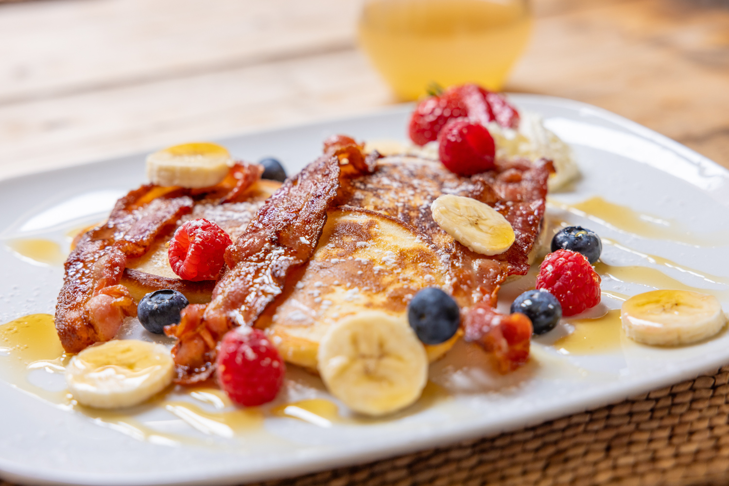 Pancakes served with fruit, bacon and maple syrup at Piglets Boutique Country Stay