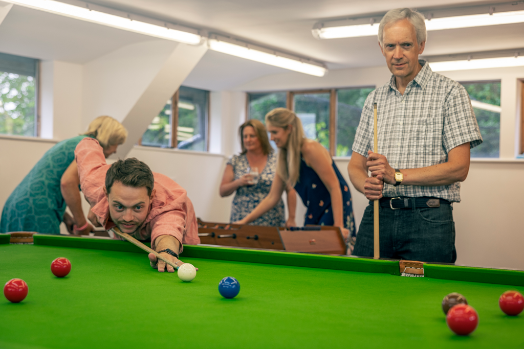 Guests playing snooker and Foosball in the games room at Piglets Boutique Country Stay winner of Best B&B of the year 2023