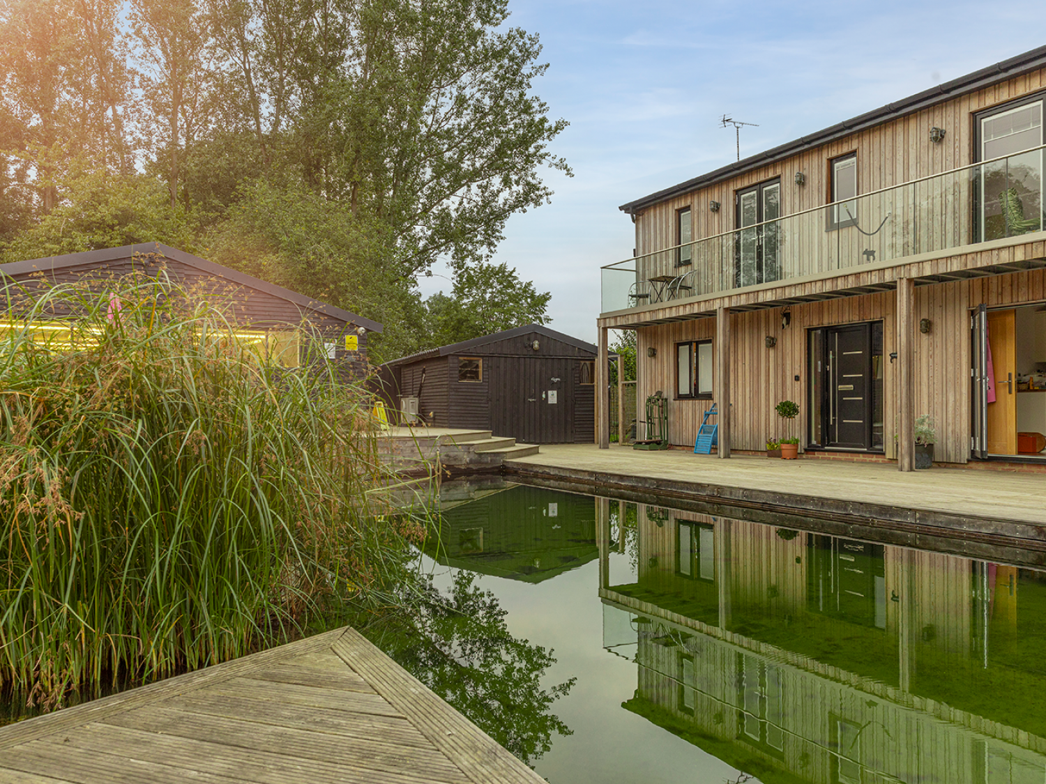 Early evening, Piglets is reflected in the eco swimming pond water